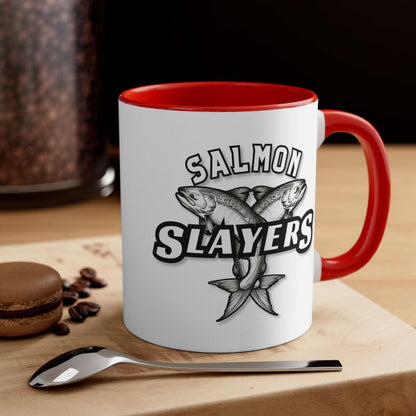 Salmon Slayers - Accent Coffee Mug, 11oz with a colored interior and handle, featuring a black and white illustration of two crossed salmons and the text "salmon slayers" on its side.