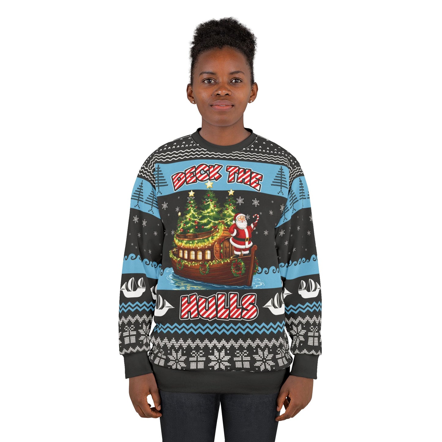 A person stands wearing the Deck the Hulls - Ugly Christmas Sweatshirt, which features a festive scene with Santa Claus, Christmas trees, and the text "Deck the Halls." The sweatshirt is adorned with a variety of winter-themed patterns including snowflakes, reindeer, and geometric designs that embody true holiday spirit.