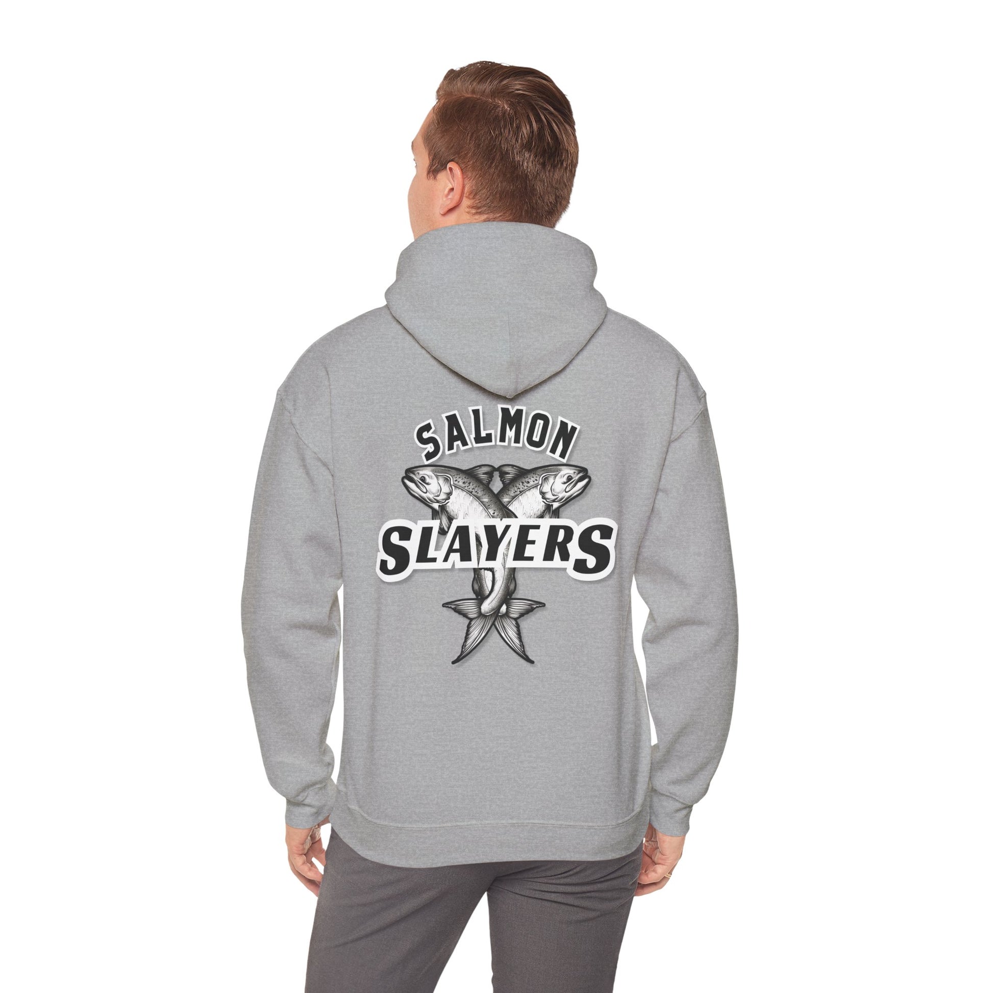 A person is wearing a Salmon Slayers - Twin Salmon Logo Hoodie crafted from a cotton/poly blend, showcasing the "Salmon Slayers" print on the back. The design features an illustration of two crossed fish with a star. This unisex hooded sweatshirt is gray, and the person is facing away to highlight the artwork.