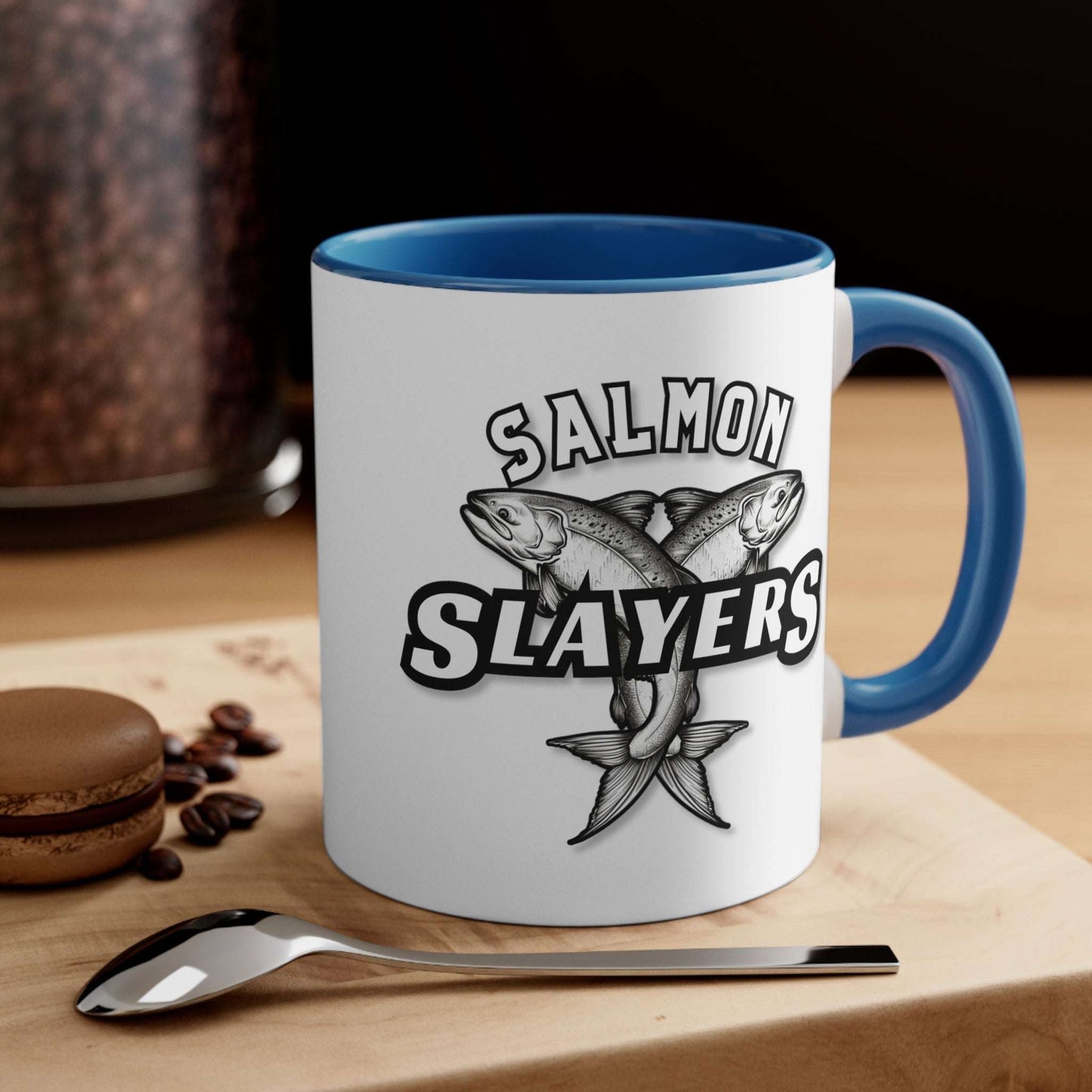 Salmon Slayers - Accent Coffee Mug, 11oz with a colored interior and handle, featuring a black and white illustration of two crossed salmons and the text "salmon slayers" on its side.