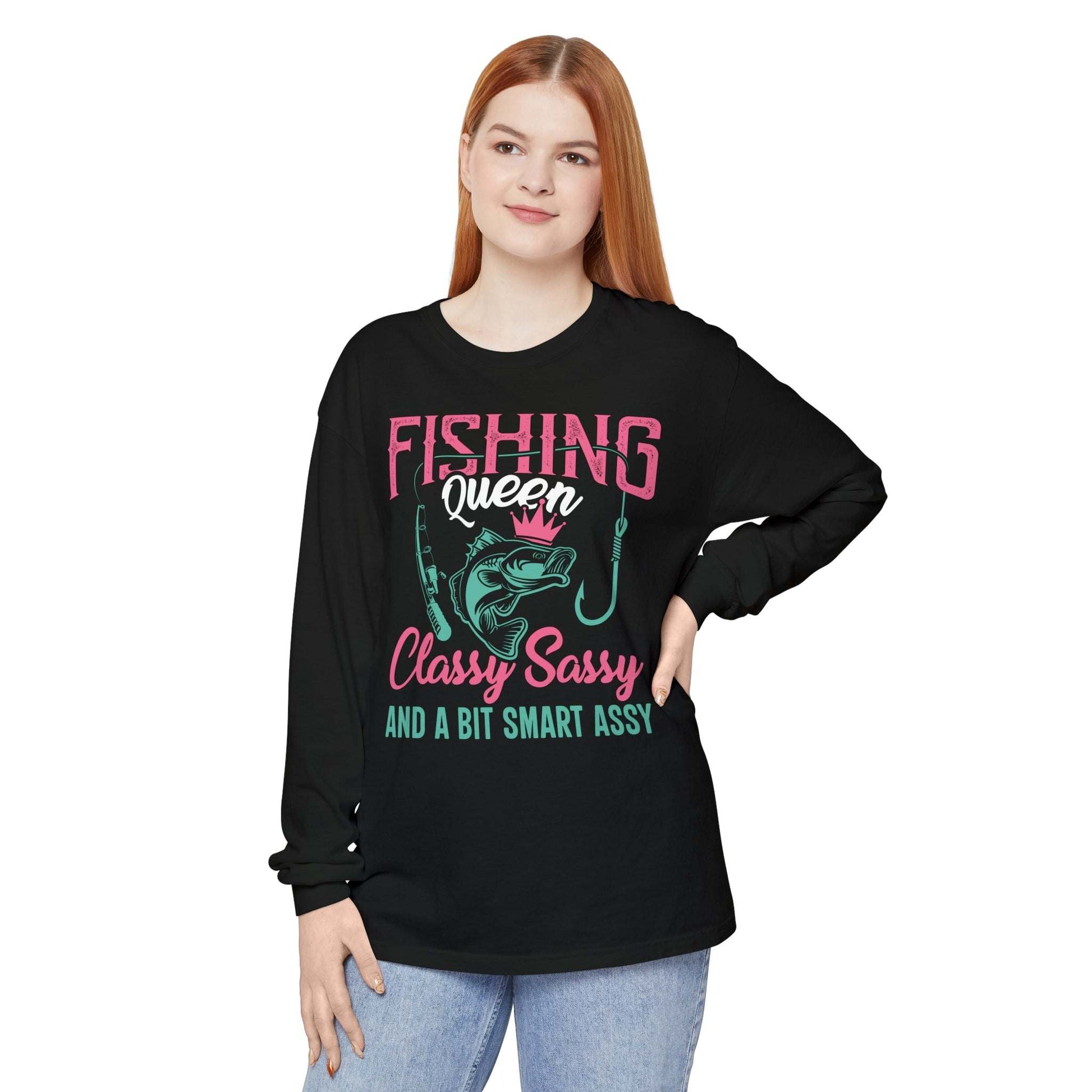 Sentence with product name: Navy blue Fishing Queen - Cotton Long Sleeve T-Shirt with pink and turquoise graphic design featuring the text "Fishing Queen" and "classy sassy and a bit smart assy" alongside an illustration of a