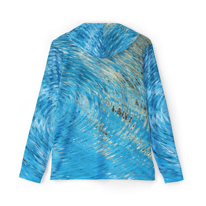 The Water Ripples Sun Protection Hoodie UPF +50 in blue is a long-sleeved garment made from moisture-wicking polyester and showcases an abstract wave-like pattern. Its design, visible from the back, gives a dynamic and textured look reminiscent of swirling water.