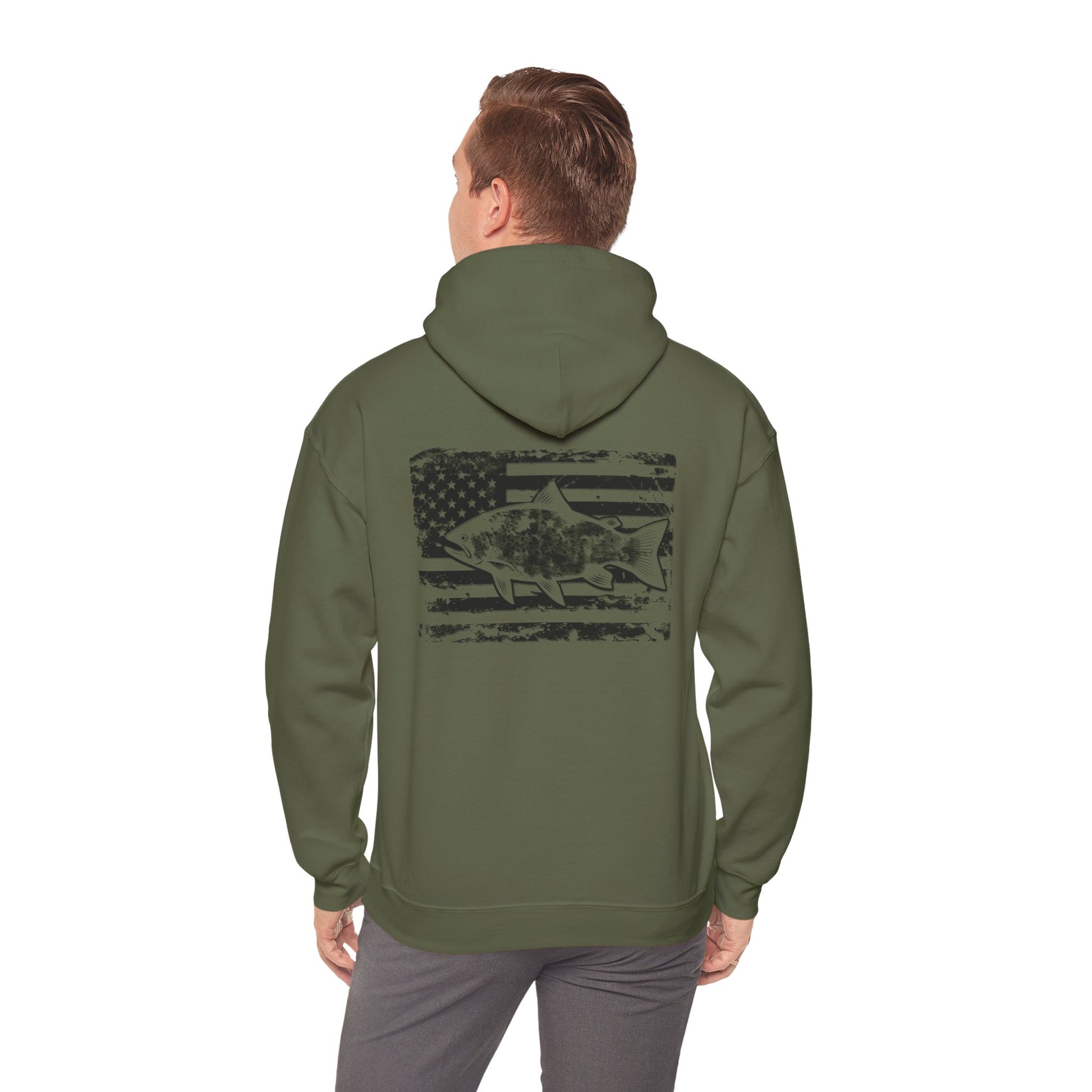 The Reeling In Freedom - Cotton/Poly Blend - Hoodie, ideal for any fishing enthusiast, is depicted from the front and back. The front showcases a small fish graphic accompanied by "Feeling of Freedom" text on the left chest, while the back prominently features a large fish graphic set against a distressed American flag design, celebrating American pride.