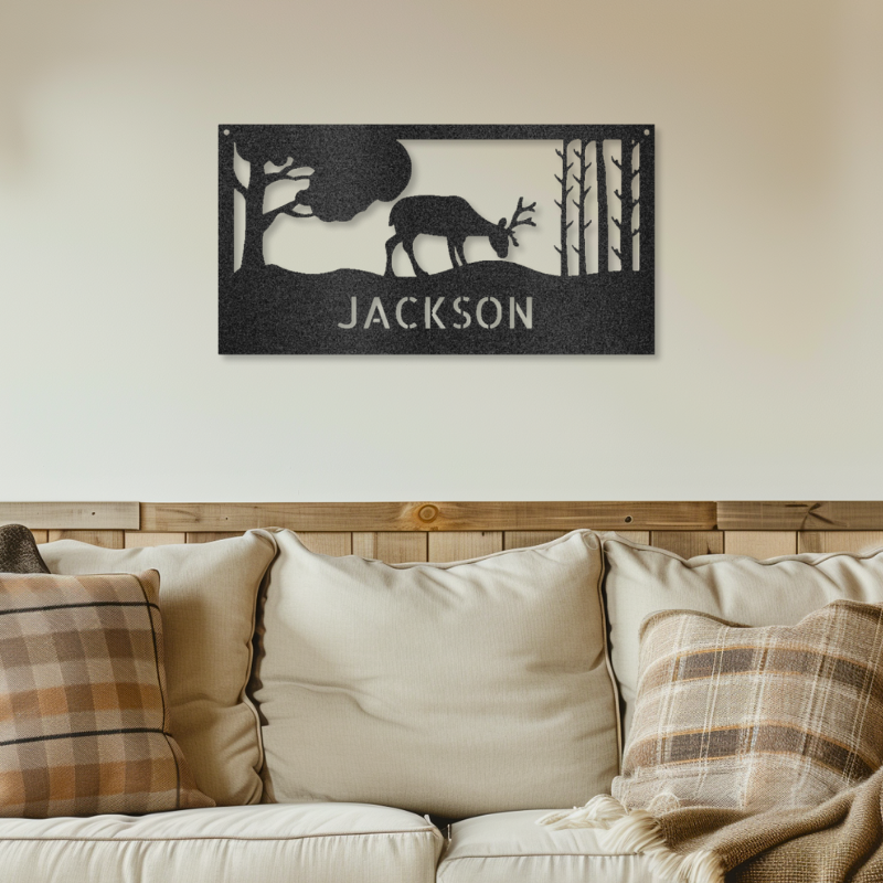 Customizable laser-cut steel sign featuring a grazing deer monogram above the name "Jackson," showcasing a serene natural scene.