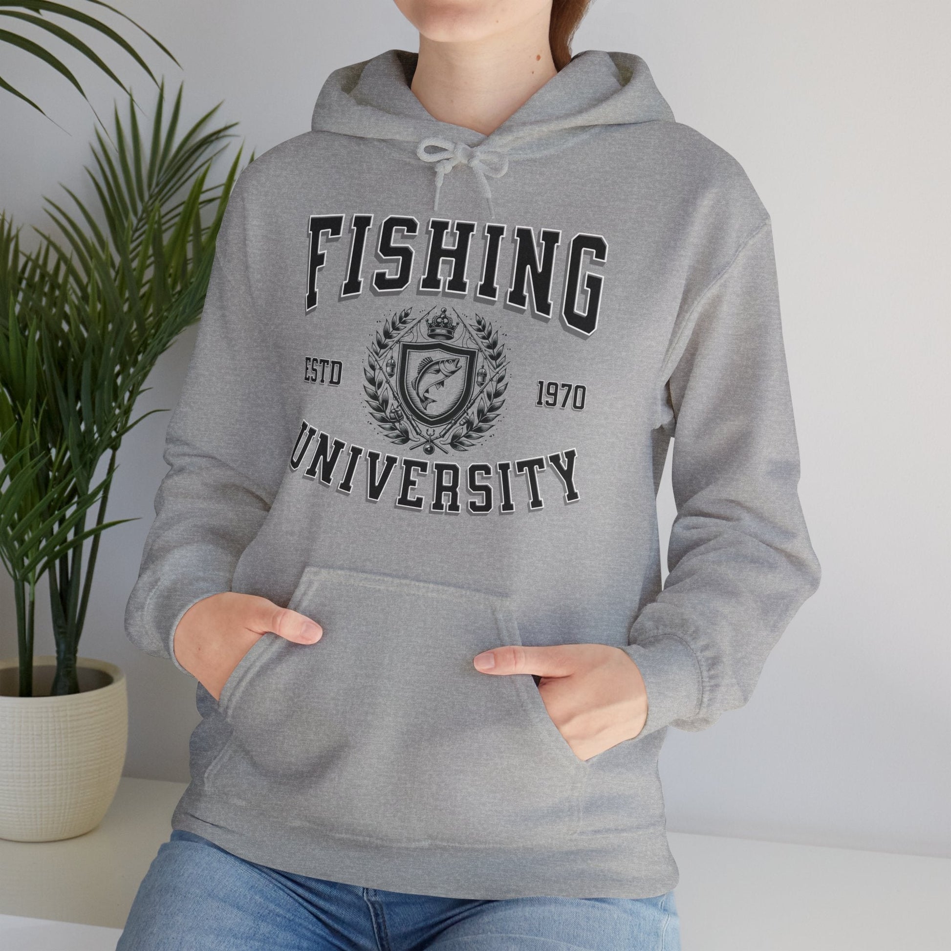 A green **Fishing University - Cotton/Poly Blend Hoodie - 7 Colors** with "Fishing University" printed in white letters on the front. The design includes "ESTD 1970" and a crest with a fish image. A red banner in the top left corner says "PERSONALIZE YEAR." This personalized hoodie features a front pocket and drawstrings.