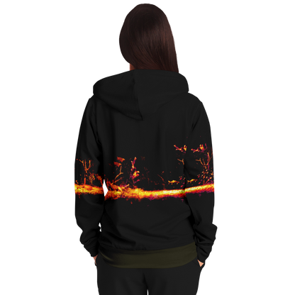 From the back, a long-haired person is seen wearing the Sonar Live Zip-Up Hoodie, which showcases a striking fiery abstract design across its back. The plain white background highlights the hoodie.