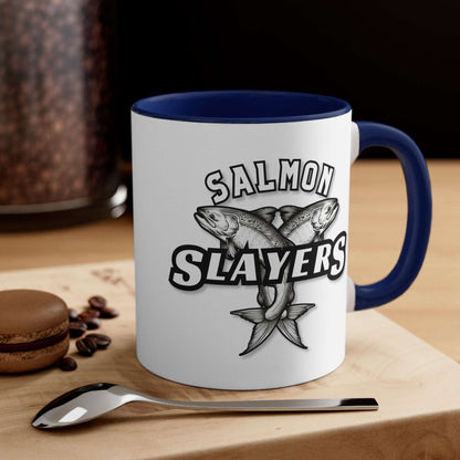 Salmon Slayers - Accent Coffee Mug, 11oz with a colored interior and handle, featuring a black and white illustration of two crossed salmons and the text "salmon slayers" on its side.