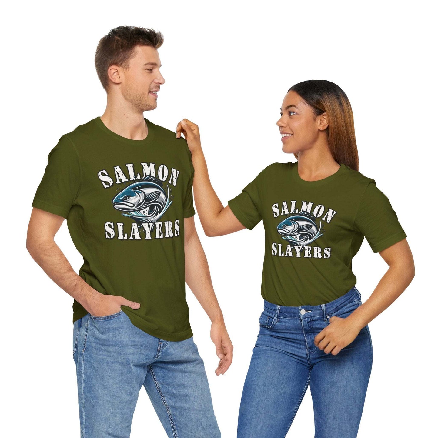 A blue unisex T-shirt made from 100% Airlume cotton featuring the text "Salmon Slayers" in bold, white, distressed letters. Below, an illustration of a fierce-looking fish with sharp teeth and dynamic lines suggests movement. Enjoy fast shipping on this striking design: **Slamon Slayers - Fierce Flash - T-Shirt**.