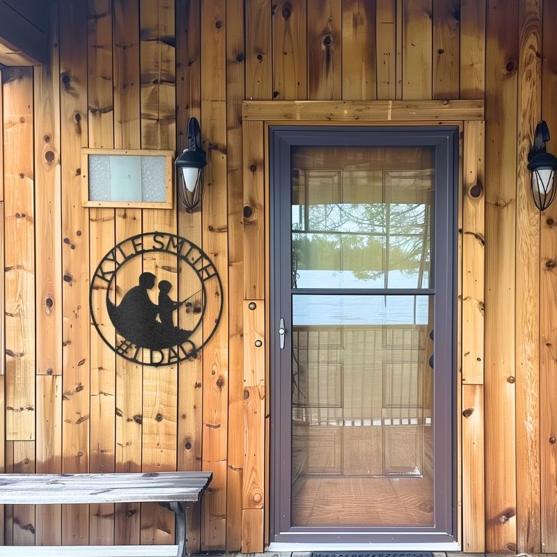 Customizable laser-cut steel sign of father and son fishing monogram on wooden wall.