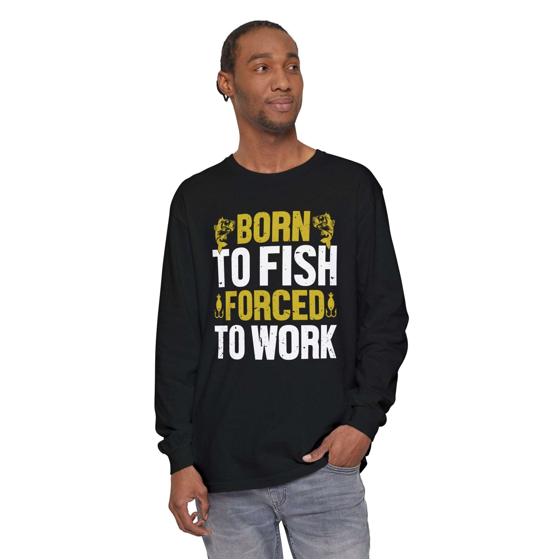 A black long-sleeve Born to Fish, Forced to Work cotton t-shirt with the text "born to fish, forced to work" printed in bold yellow and white letters, flanked by fishing hook graphics.