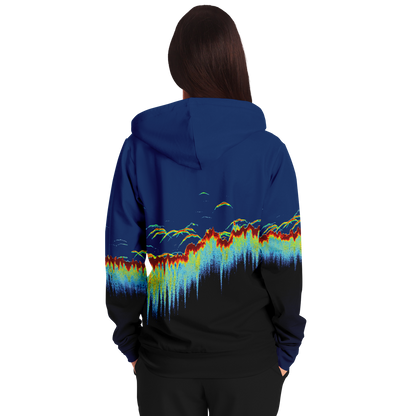 The Sonar Scan Zip-Up Hoodie - Tri-Blend is a unisex hoodie with a vibrant design on the back. The pattern showcases colorful, wave-like shapes in red, yellow, green, and blue set against a gradient background that transitions from dark blue at the top to black at the bottom. The hood features a solid dark blue color.