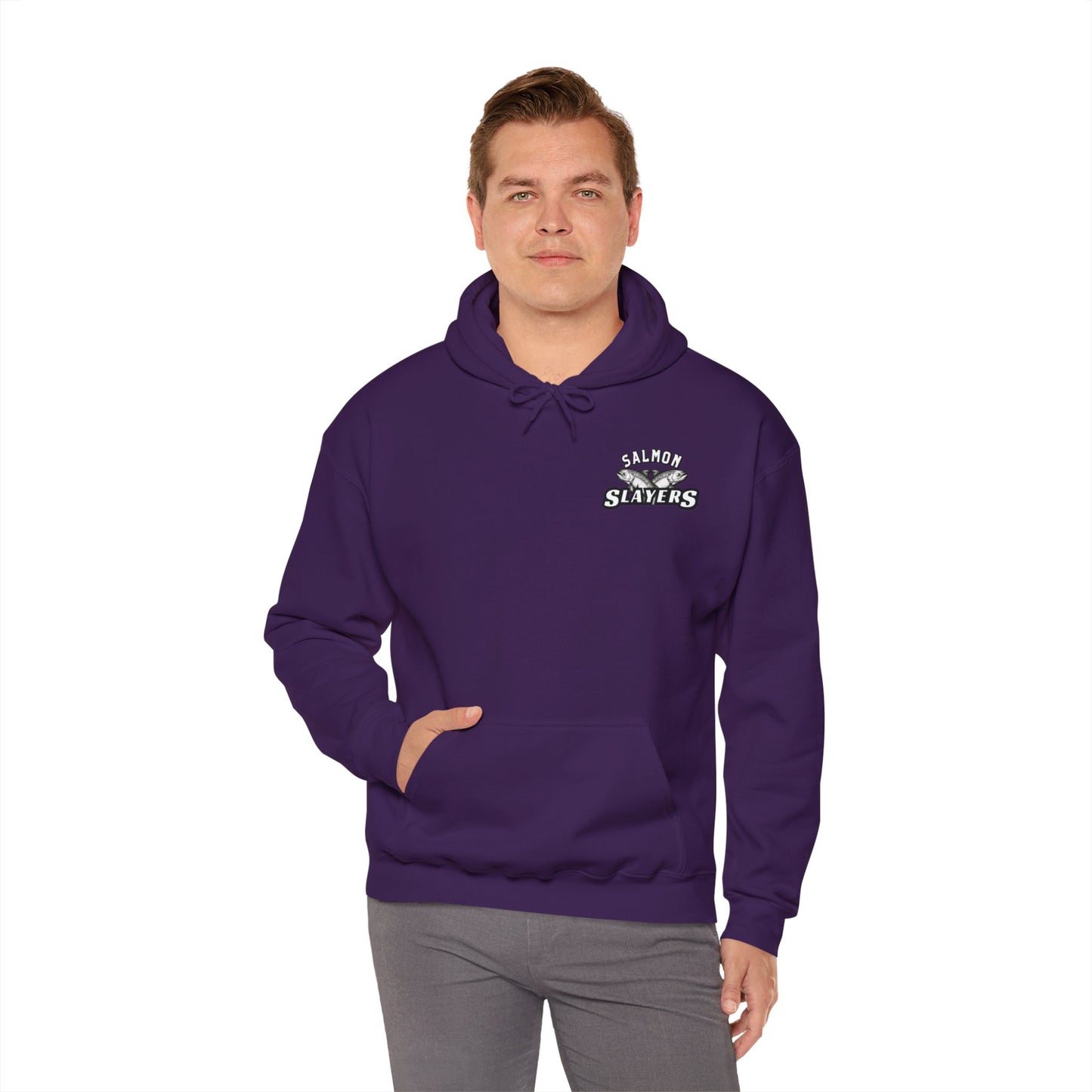 A person wearing a dark purple Salmon Slayers - Twin Salmon Logo Cotton/Poly Blend Hoodie stands against a plain white background. "Salmon Slayers" is printed on the upper left side, with one hand in the hoodie pocket and the other at their side, showcasing this unisex hooded sweatshirt.