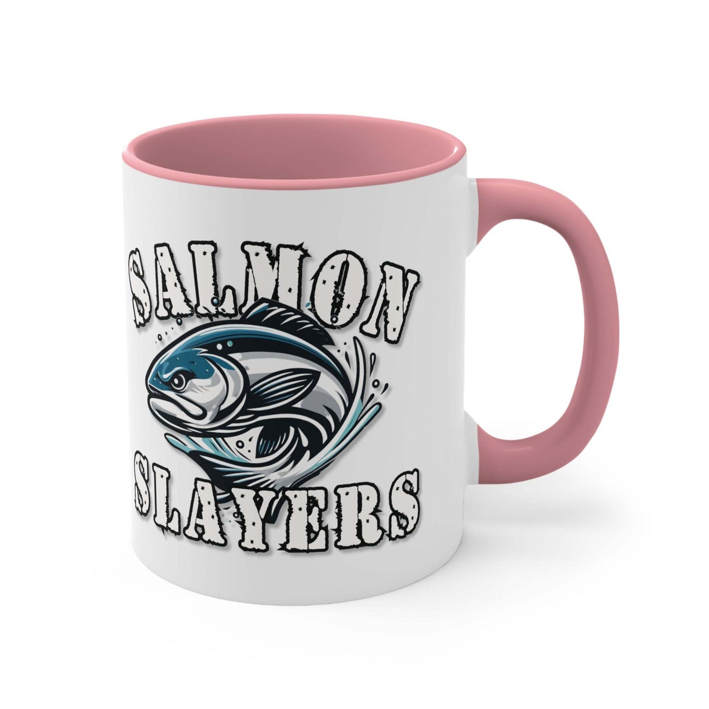 A white custom Salmon Slayers - Fierce Flash - Accent Coffee Mug, 11oz with a blue interior and C-handle features the design "Salmon Slayers" with a stylized illustration of a salmon in the center. The mug, showcasing an eye-catching color contrast, is placed on a wooden surface next to a small macaron, coffee beans, and a spoon.