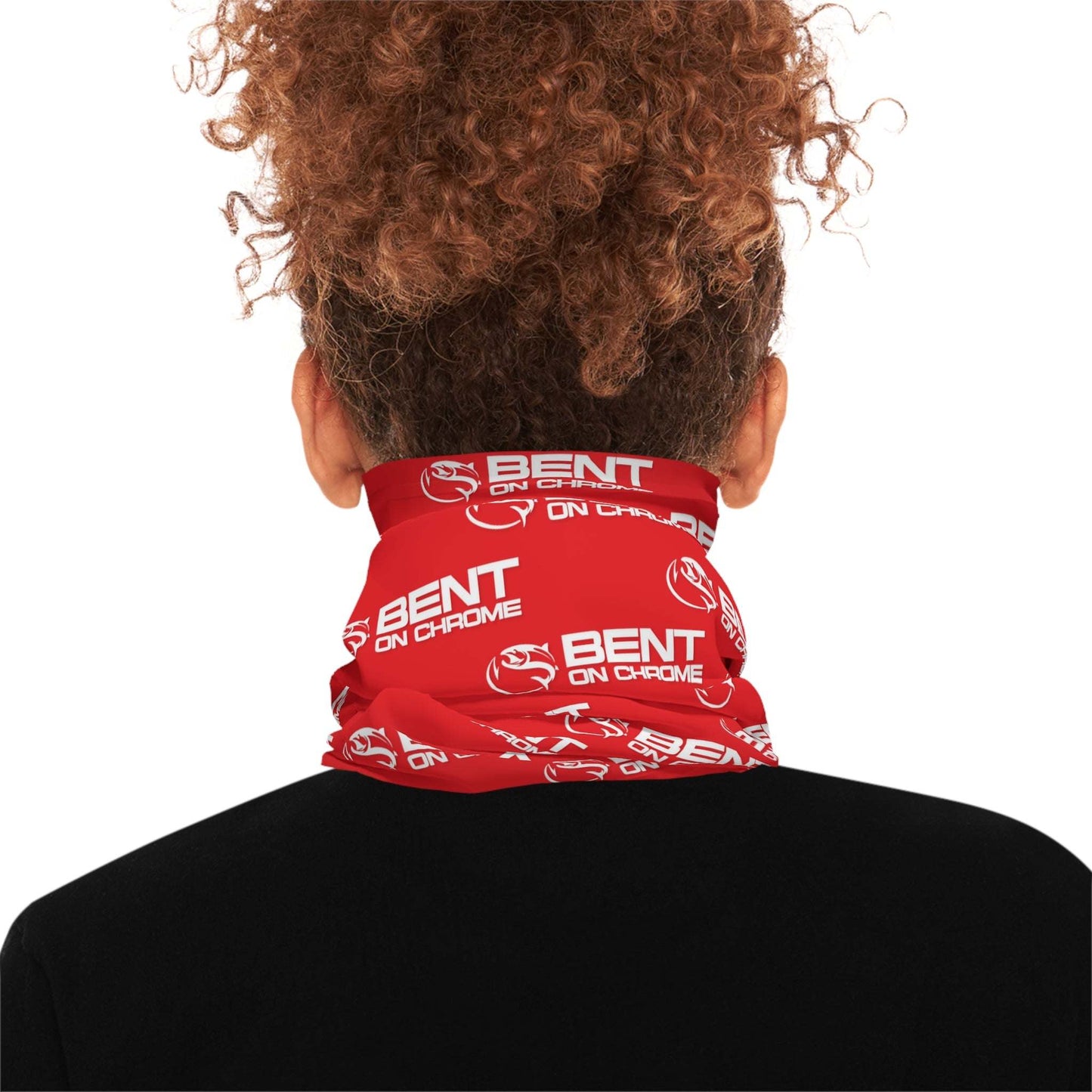 A woman wearing a black top and a red Bent On Chrome - Lightweight Neck Gaiter with the text "bent on chrome" printed in white. Her hair is styled in a curly updo, and she is