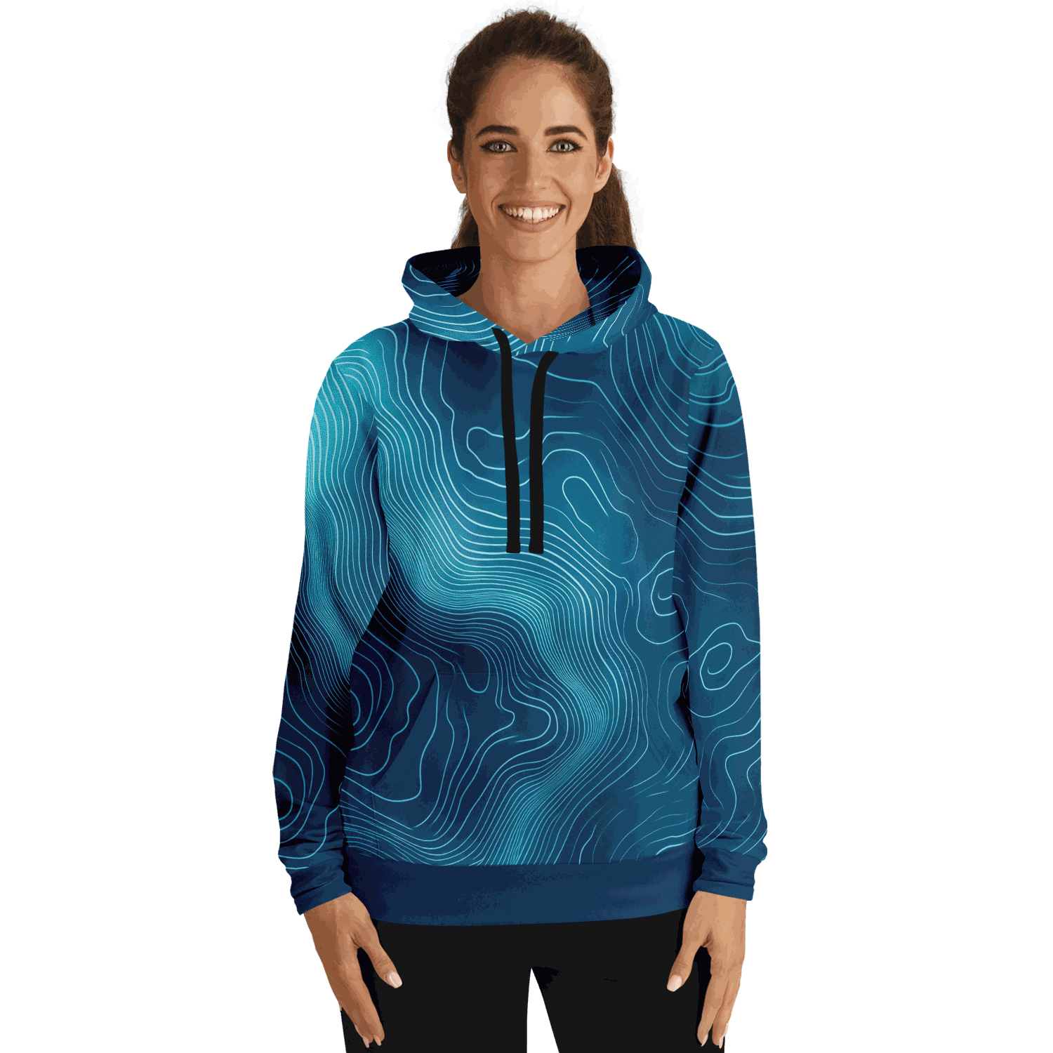 A woman, smiling against a black background, is wearing a Deep Blue Depth Map Pull Over Hoodie in tri-blend material with abstract, underwater contour-like light blue lines. The hoodie features a black drawstring. She pairs it with black pants, her hair tied back, and her hands resting at her sides.