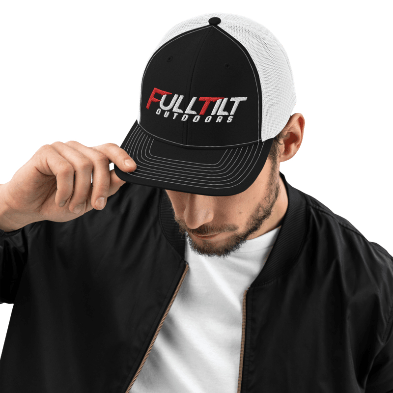 A black and gray Full Tilt Outdoors - Richardson 112 - Trucker Cap with the logo "fulltilt outdoors" in bold red and white lettering on the front, featuring an adjustable snapback.