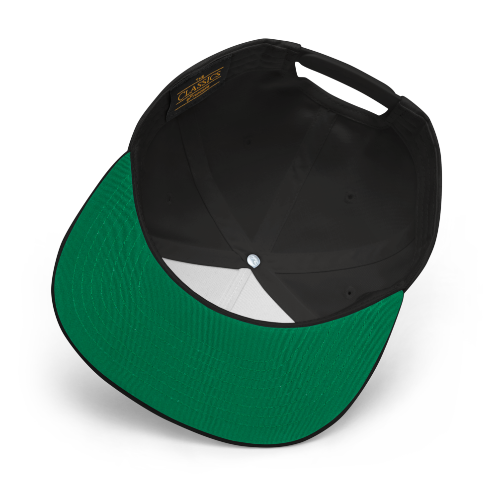 The image presents the interior of the Salmon Slayers - Flat Bill Cap, showcasing its black cotton twill construction with a green brim. The cap is adorned with a label marked "CLASSIC" and additional text that is partially obscured. There are stitching lines visible on the underside of the brim, and a small metal button is positioned at the top.