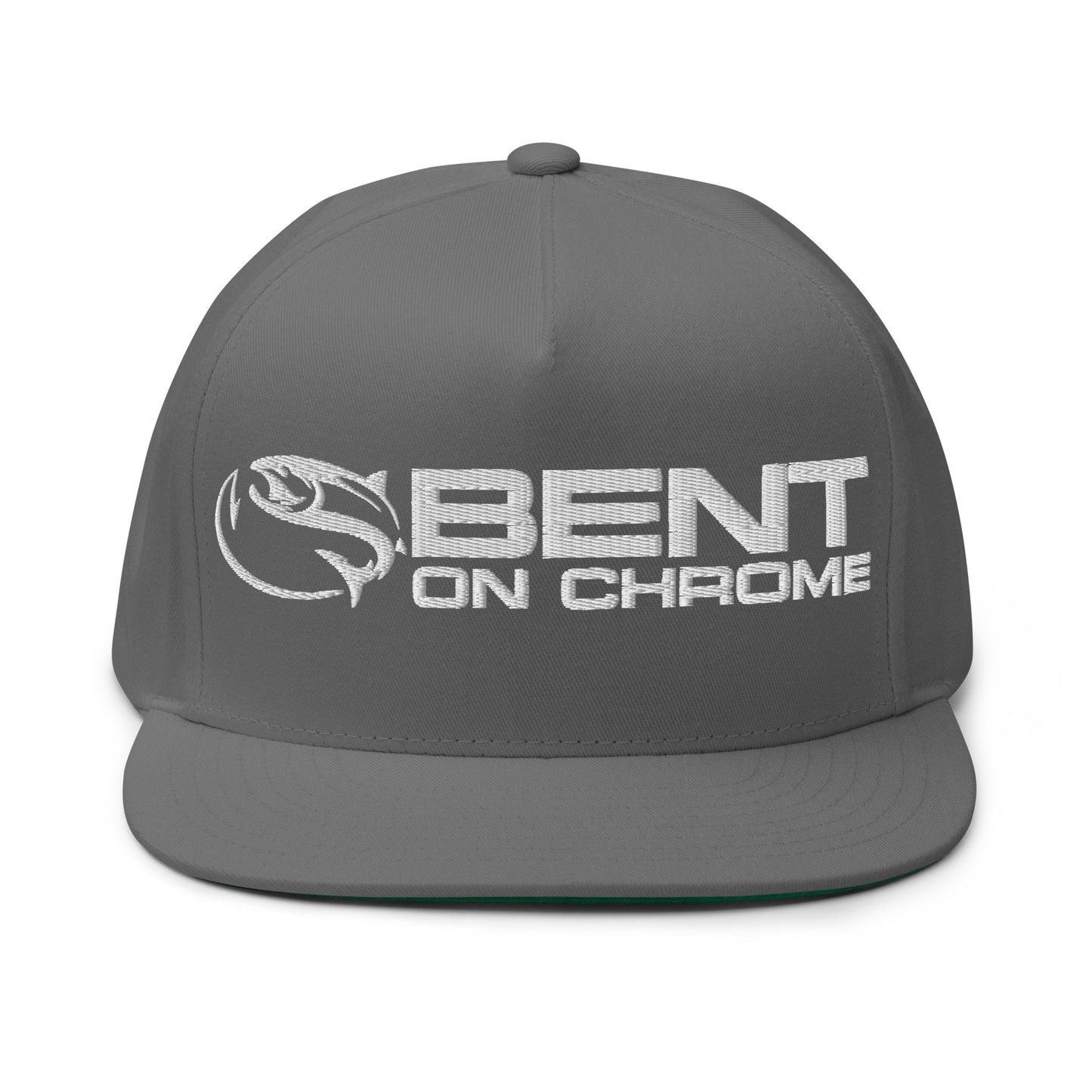 The "Bent on Chrome - Flat Bill Cotton Twill Cap - Puffer Embroidery" is a gray snapback cap featuring "BENT ON CHROME" embroidered elegantly in white on the front, alongside a stylized fish logo. Crafted from durable cotton twill, it boasts a flat brim and a structured crown, complete with an adjustable snapback closure for a perfect fit.