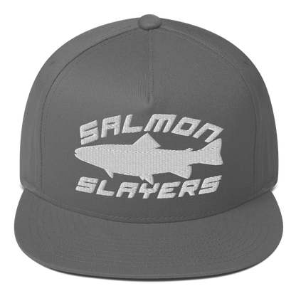 A black ***Salmon Slayers - Sport - Flat Bill Cap*** with a high-profile fit and snapback closure, featuring an embroidered design of a stylized salmon and "SALMON SLAYERS" in bold white letters above and below the fish. The green undervisor adds a unique touch to this stylish cap.