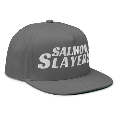 The Salmon Slayers Flat Bill Cap is a gray snapback hat emblazoned with "SALMON SLAYERS" in bold white text on the front, made from soft cotton twill and featuring an adjustable snapback closure for optimal fit.