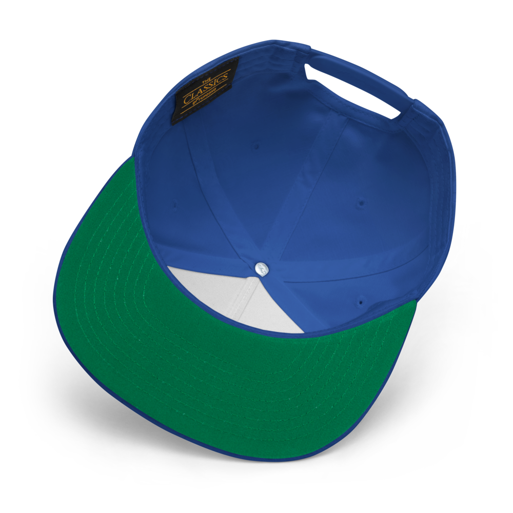 The "Salmon Slayers - Flat Bill Cap" is designed with a blue cotton twill exterior and a green underside of the flat brim. This fashionable cap features an interior fabric panel and a sewn-in label, while its snapback closure allows for an adjustable fit.