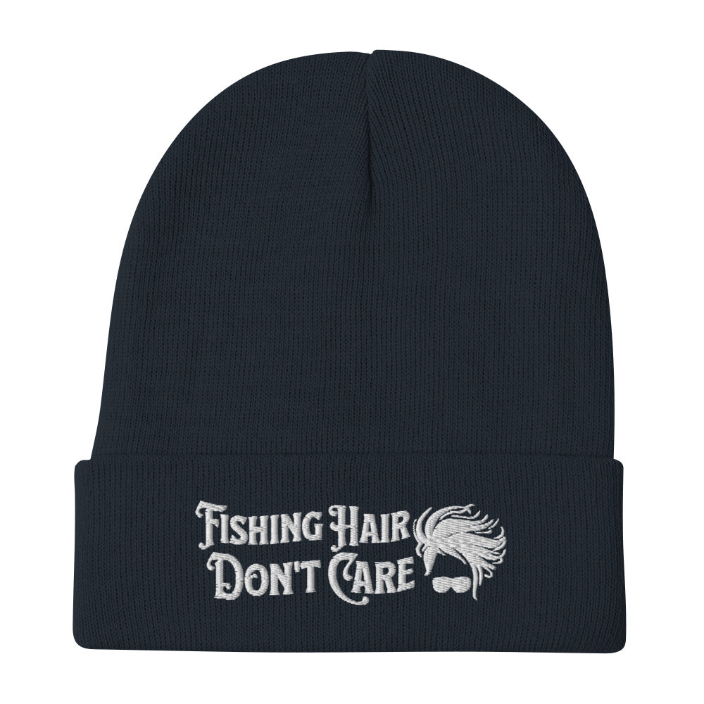 A black Beanie - Fishing Hair Don't Care with a snug fit and the text "Fishing Hair Don't Care" embroidered in white. The design is complemented by a simple graphic of curly hair and sunglasses.