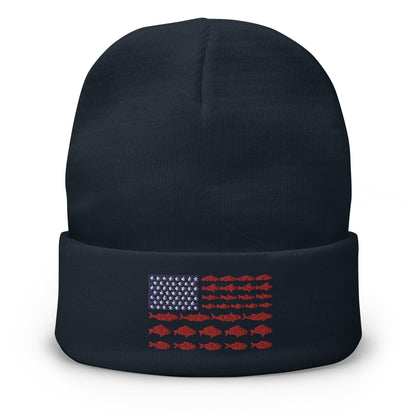 The "Fishing Flag - Embroidered Beanie" is a gray hat featuring a unique patriotic design on the front. The design resembles the American flag, with white stars on a blue background in the top left corner and horizontal red stripes made up of fish, instead of the traditional solid stripes.