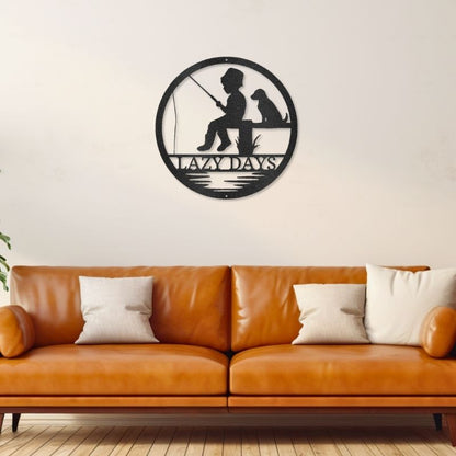 Customizable laser-cut steel sign featuring a child fishing with a dog, 'Lazy Days' design, displayed above a couch.