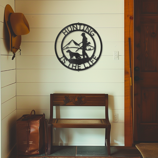 Hunter-themed laser-cut steel sign featuring a customizable monogram, depicting a hunter and dog in a mountain scene, for outdoor enthusiasts.