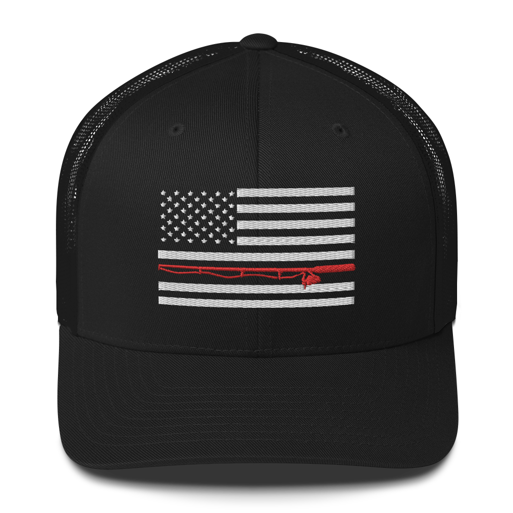 A black Fishing Flag Trucker Cap with an embroidered design of the American flag in white and gray. One of the horizontal stripes is red and features a silhouette of a bass fish. The flag design is centered on the front panel of this fishing enthusiasts hat.