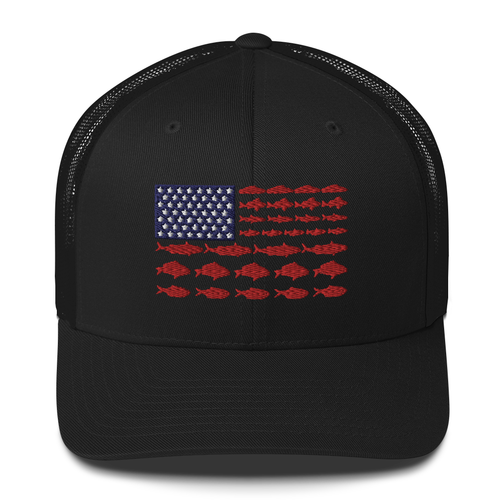 This Fishy Flag Trucker Cap is a black baseball cap featuring an American flag design made up of fish. The blue and white stars section is in the top left, while the red stripes are composed of small fish silhouettes, making it perfect for fishing enthusiasts.