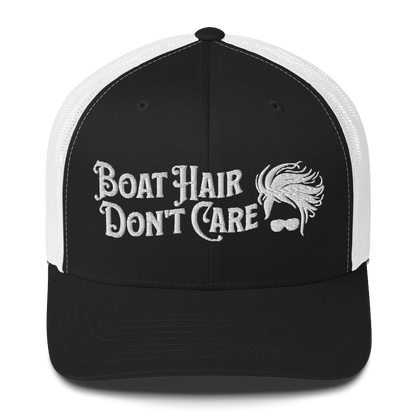 A Boat Hair, Don't Care - Trucker Style Fishing Cap with white mesh backing featuring the embroidered text "Boat Hair Don't Care" alongside a stylized illustration of hair blowing in the wind and a pair of sunglasses, making it the perfect fishing cap for your next adventure.