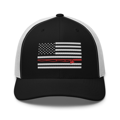 A black Fishing Flag Trucker Cap with an embroidered design of the American flag in white and gray. One of the horizontal stripes is red and features a silhouette of a bass fish. The flag design is centered on the front panel of this fishing enthusiasts hat.