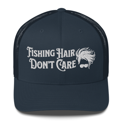 A black and white Fishing Hair, Don't Care - Trucker Style Fishing Cap with a curved brim and mesh back. The front of the cap features the embroidered text "Fishing Hair Don't Care" in white thread next to an image of stylized windblown hair and stylish sunglasses, perfect for fishing enthusiasts.