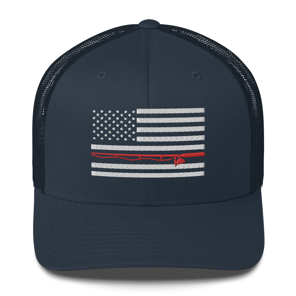 A black Fishing Flag Trucker Cap with an embroidered design of the American flag in white and gray. One of the horizontal stripes is red and features a silhouette of a bass fish. The flag design is centered on the front panel of this fishing enthusiasts hat.