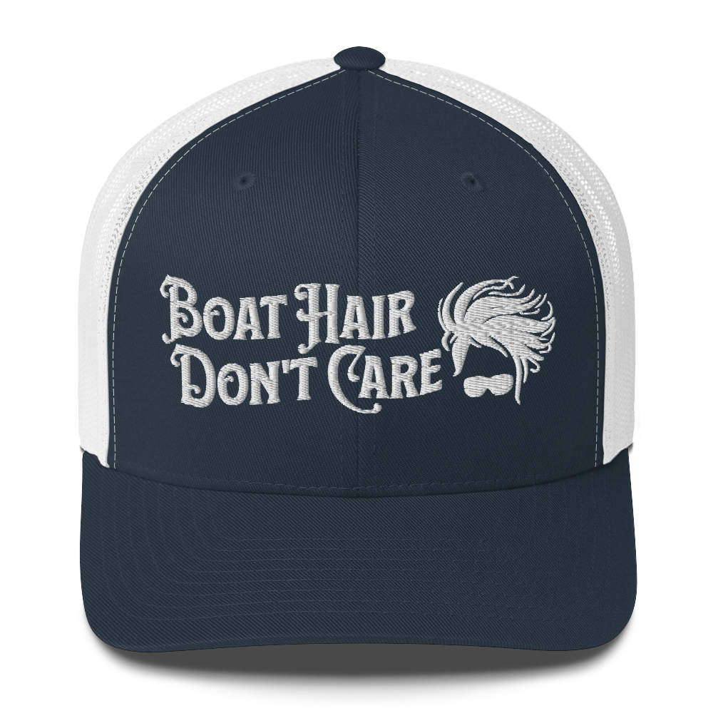 A Boat Hair, Don't Care - Trucker Style Fishing Cap with white mesh backing featuring the embroidered text "Boat Hair Don't Care" alongside a stylized illustration of hair blowing in the wind and a pair of sunglasses, making it the perfect fishing cap for your next adventure.