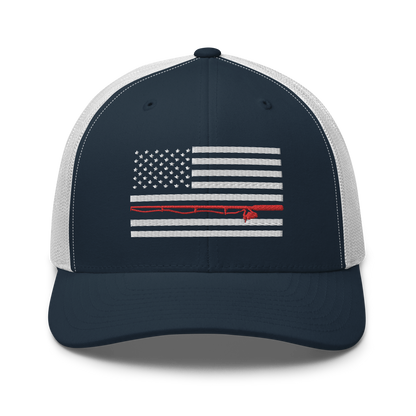 A black Fishing Flag Trucker Cap with an embroidered design of the American flag in white and gray. One of the horizontal stripes is red and features a silhouette of a bass fish. The flag design is centered on the front panel of this fishing enthusiasts hat.