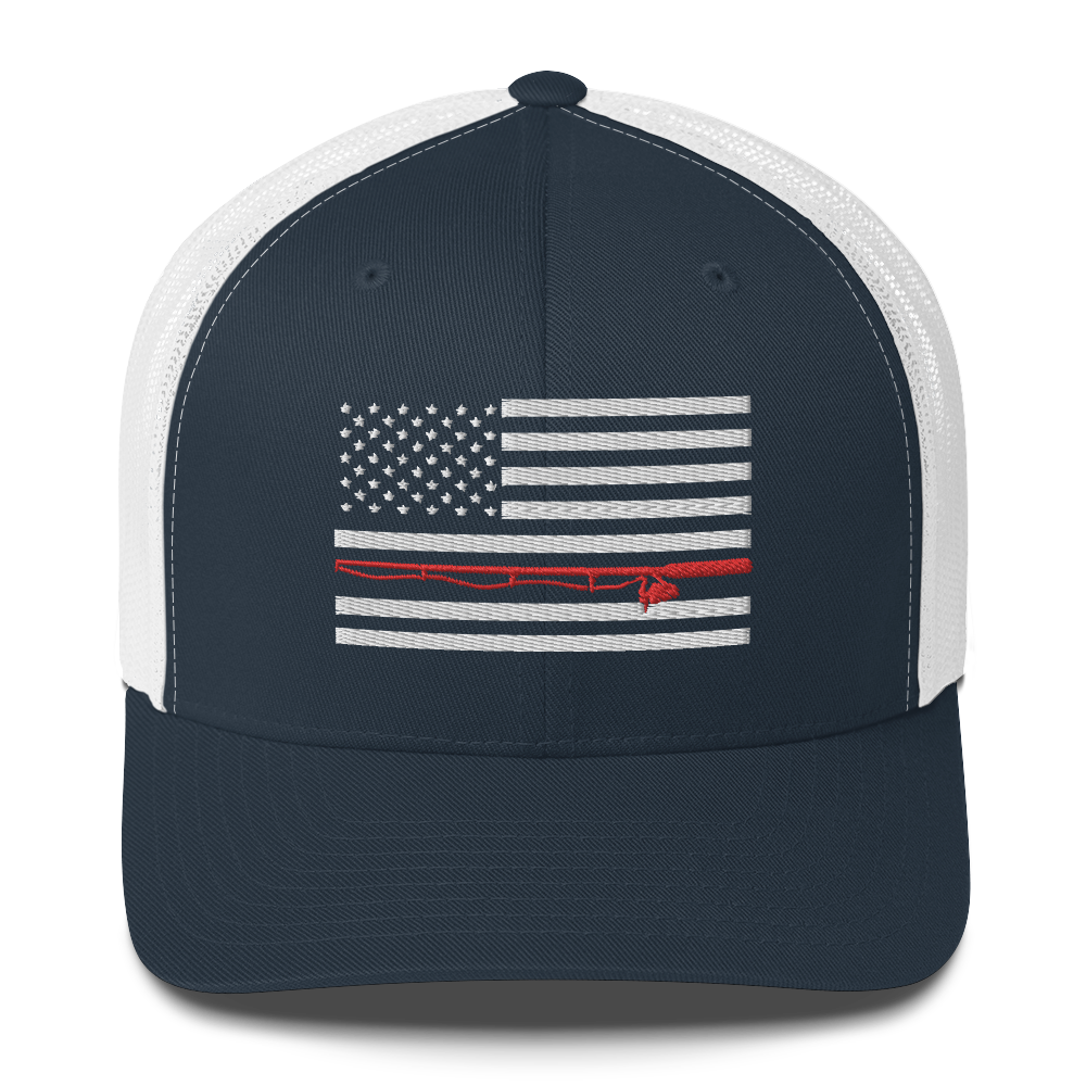 A black Fishing Flag Trucker Cap with an embroidered design of the American flag in white and gray. One of the horizontal stripes is red and features a silhouette of a bass fish. The flag design is centered on the front panel of this fishing enthusiasts hat.