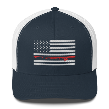 A black Fishing Flag Trucker Cap with an embroidered design of the American flag in white and gray. One of the horizontal stripes is red and features a silhouette of a bass fish. The flag design is centered on the front panel of this fishing enthusiasts hat.