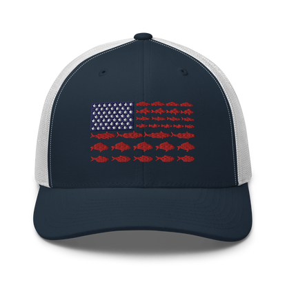 This Fishy Flag Trucker Cap is a black baseball cap featuring an American flag design made up of fish. The blue and white stars section is in the top left, while the red stripes are composed of small fish silhouettes, making it perfect for fishing enthusiasts.