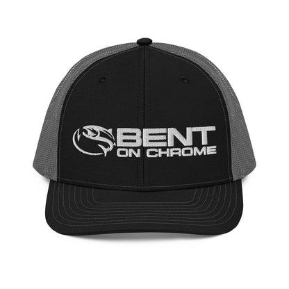 A black and gray Bent on Chrome - Richardson 112 Trucker Cap with Puffer Embroidery featuring the logo "bent on chrome" with a stylized wing design on the front panel. The cap has a mesh back, an adjustable snap