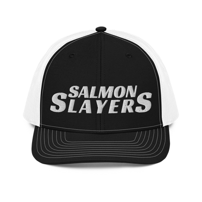 A black and gray mesh Salmon Slayers - Richardson 112 - trucker cap with the words "salmon slayers" embroidered in bold, white letters across the front.