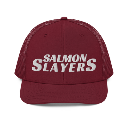 A black and gray mesh Salmon Slayers - Richardson 112 - trucker cap with the words "salmon slayers" embroidered in bold, white letters across the front.