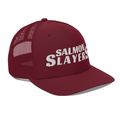 A black and gray mesh Salmon Slayers - Richardson 112 - trucker cap with the words "salmon slayers" embroidered in bold, white letters across the front.